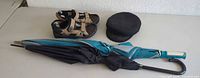 Showing all items: FootJoy golf sandals, black and teal striped golf umbrellas, and vintage Greek fisherman's cap.