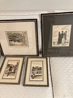 Five framed sketches and drawings lying against a wall showing overall lot contents.