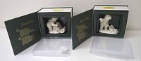 Two Snowbabies figurines in their original green display boxes, showing both 'Making a List' and 'Shovelling Snow'.