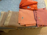 Five wool blankets laid out on mattress, showing variety of colors and labels