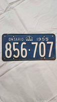 Front view showing entire licence plate, number, text and colour