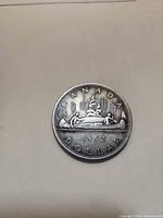 Reverse side of 1962 Canadian silver dollar showing canoe design