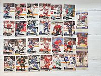 Full layout of 24 hockey cards with three sleeved on right