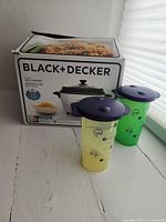 Boxed Black+Decker rice cooker with two Tupperware tumblers
