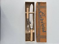 Knife, fork and box laid in tray
