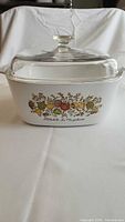 Front view of CorningWare casserole with lid showing vegetable motif and pattern name