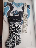 All items laid out: jersey, belt, extra buckle, stocking