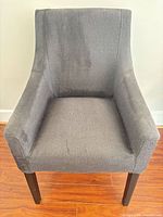 Front view of gray fabric accent armchair showing seat, backrest and arm design