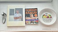 Group shot showing both cookbooks, garlic press and pie plate