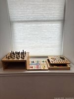 Multi-game wooden set with chess, Parcheesi and peg boards displayed