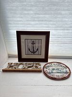 overall view of framed anchor print, HOPE sign, and oval plaque