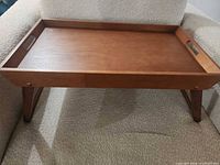 Tray set up on chair with legs extended