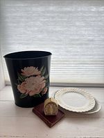 group shot of wastebasket, timer, two plates and book