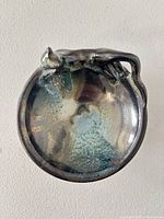 Top view of ceramic dish showing glaze and cat figure