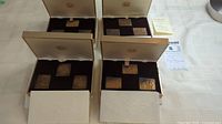 Four boxed sets of bronze Olympic sculpture plaques with original Canadian Olympic boxes.
