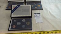 Photo showing one of three 1988 Royal Canadian Mint specimen coin sets including six coins in protective case inside a blue presentation folder.