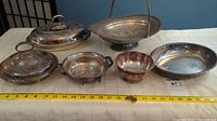 Full view of the six EP silverware pieces arranged on table with measuring tape