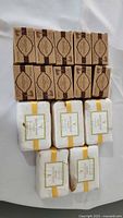 15 brown boxed soap bars and 10 white wrapped soap bars arranged in a grid.