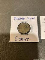 Photo of the 1943 Canadian 5 cents Victory Nickel coin in a white 2x2 coin holder with handwritten label.