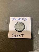 Front view of 1951 Canadian 5 cent nickel coin in protective holder labeled 'Canada 1951 5 cent'.