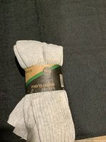 Three pairs of Basics men's crew socks, light grey color, bundled and labeled size 10-13.
