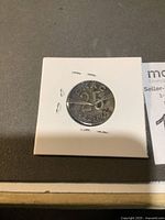 Front side of CKAC commemorative coin showing inscription CKAC 25 1922-1947 in protective holder.