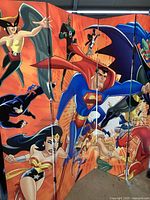 Side angle view showing superhero characters on canvas panels of the room divider.