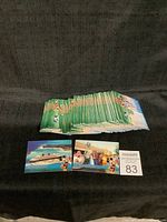 Stack of over 50 Disney collectible cards with two cards placed in front showing colorful Disney scenes.