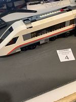 Side view of the LEGO white and gray locomotive showing the set number 60051 and window details.