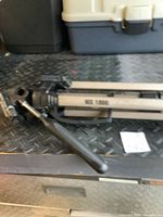 Photo showing the MK-7000 label on the aluminum tripod leg, pan-and-tilt head with handle, and quick-release mechanism.