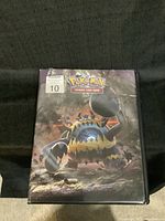 Front cover of the Pokémon trading card binder featuring a large Pokémon character artwork and label with number 10.