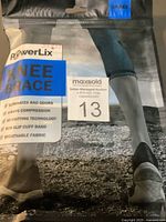 Photo of PowerLix knee brace in original packaging showing branding and key features.