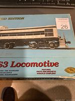 Photo of Proto 2000 S3 Locomotive limited edition box with visible damage and wear, showing locomotive image and branding on cover.