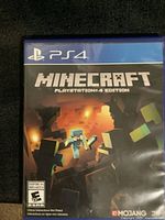 Front cover of Minecraft PS4 game case showing game title, platform, and Mojang logo.