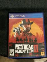 Front cover of Red Dead Redemption II PS4 game case showing character with revolver and western background.