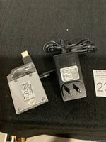 Top view of Targus branded USB hub with power adapter placed on black fabric surface.