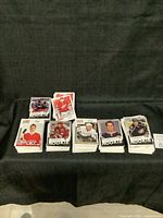 Stacks of hockey trading cards from the Victory Rookie series, showing multiple players in different team jerseys, rookie cards with Victory branding.