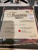 Photo showing the label on the packaged duvet cover, brand Wabasso, Trousseau line, king size 260 x 230 cm, 50% cotton 50% polyester, made in Canada.
