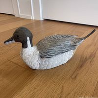 Full side view of the wooden duck decoy showing the full body carving and paint.