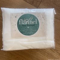 Photo showing the packed off-white soft flannel sheet set with label