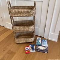 Front view of three-tier bamboo organizer with all accompanying items displayed on floor next to it.