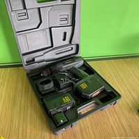 Wagner cordless drill inside black plastic carrying case with two 18V batteries and charger visible.