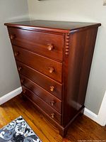 Antique maple dresser showing front and side view with five drawers and beaded corner detail.