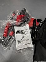 Photo of new Bauer 9 inch variable speed drywall sander wrapped in plastic along with owner's manual and black carrying bag.
