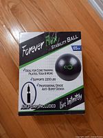 Box showing Forever Flex Stability Ball branding, 65 cm size, air pump included, supports 2200 lbs, anti-burst design