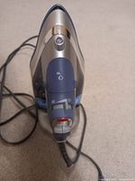 Top view photo showing the soleplate of the electric steam iron with power cord visible.