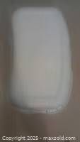 Top view of the white plastic container showing closed lid and overall shape.