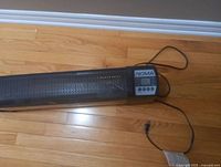 Front view of the NOMA electric space heater off showing the digital control panel and mesh grille