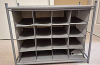Front view of shoe rack showing 20 fabric cubbies in 4x5 grid.