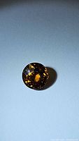 Single round burnished orange champagne colored gemstone in 7mm size with detailed flower cut facets.